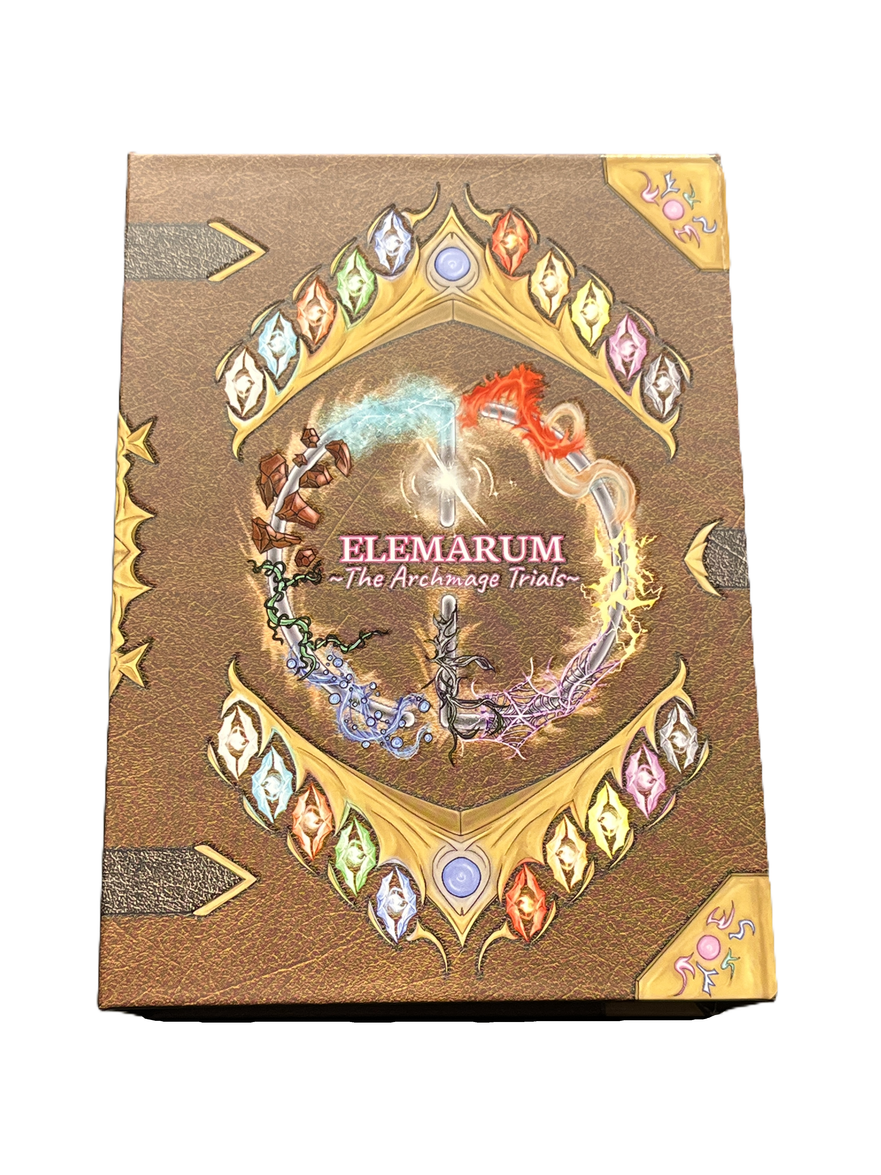 An image of the front of the Elemarum: The Archmage Trials game box, which looks like a leatherbound book covered in magical gemstones.